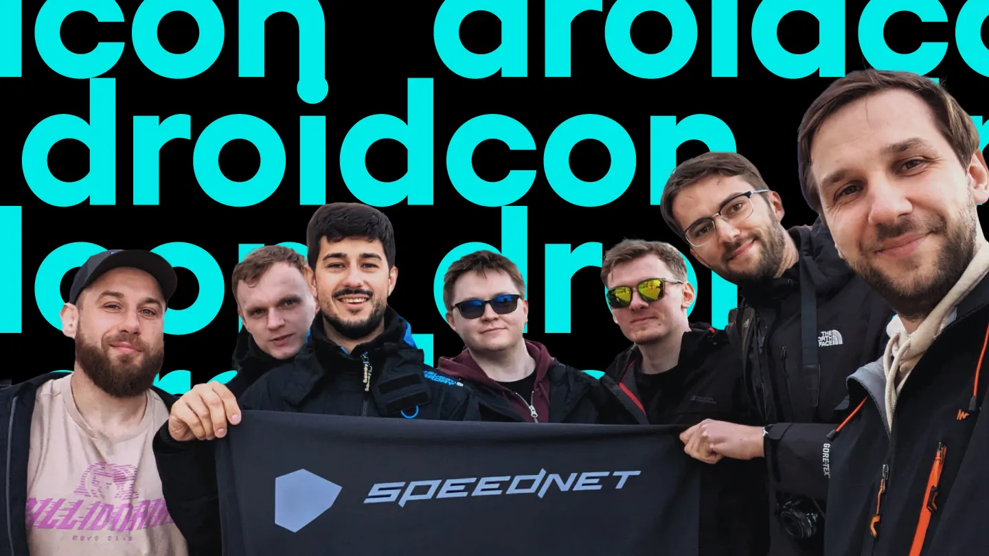 The #TeamSpeednet group holding a Speednet banner in front of a "droidcon" text pattern.