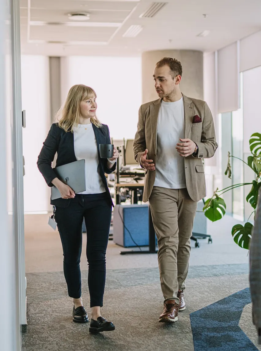 Speednet team members walking and talking in the office.