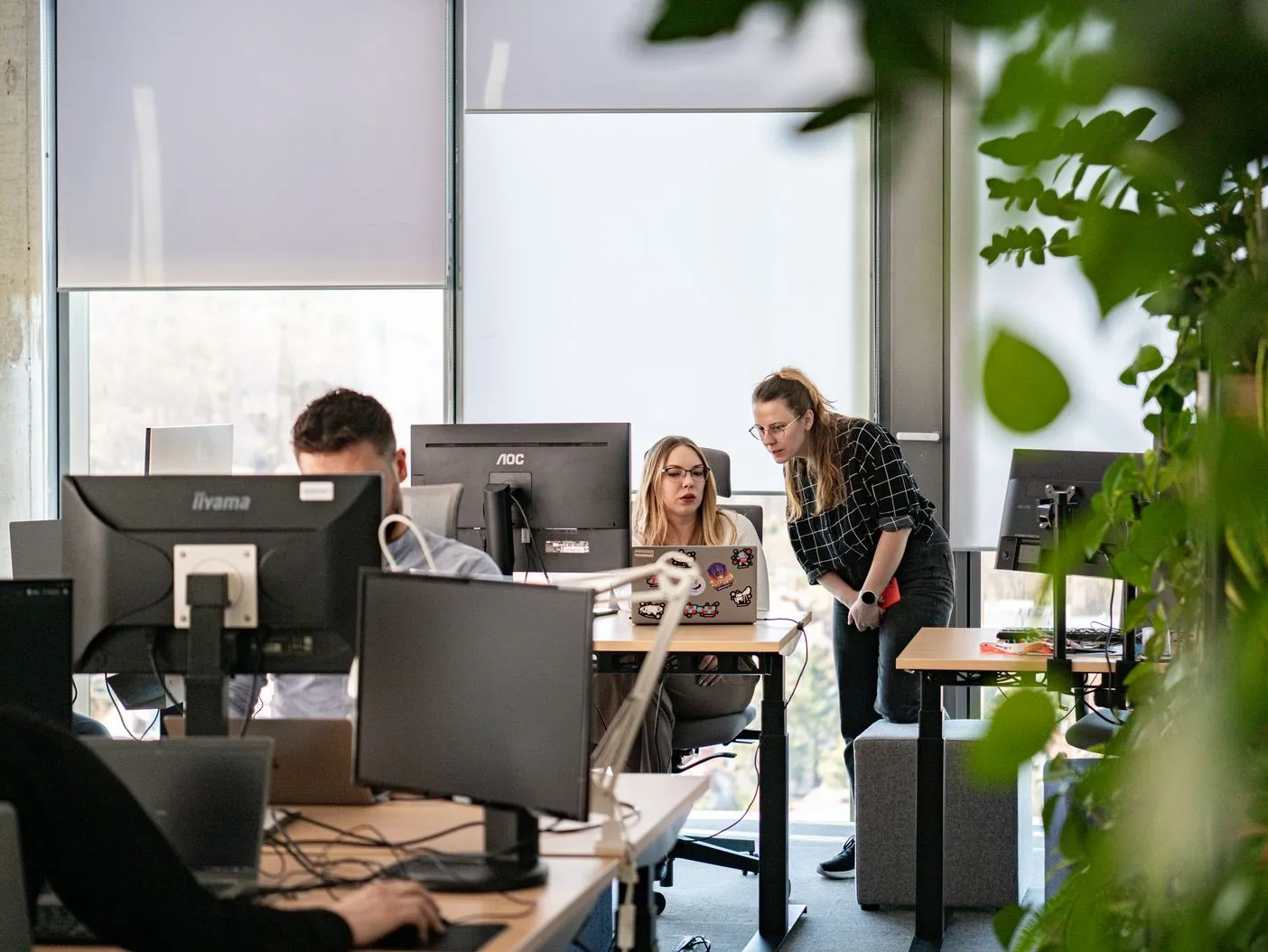 Speednet team members working at their desks in an open-plan office.