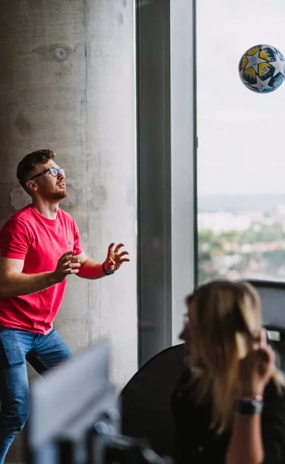 A Speednet team member playing with a ball by the office window.