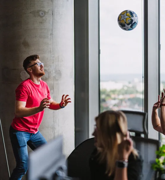 A Speednet team member playing with a ball by the office window.