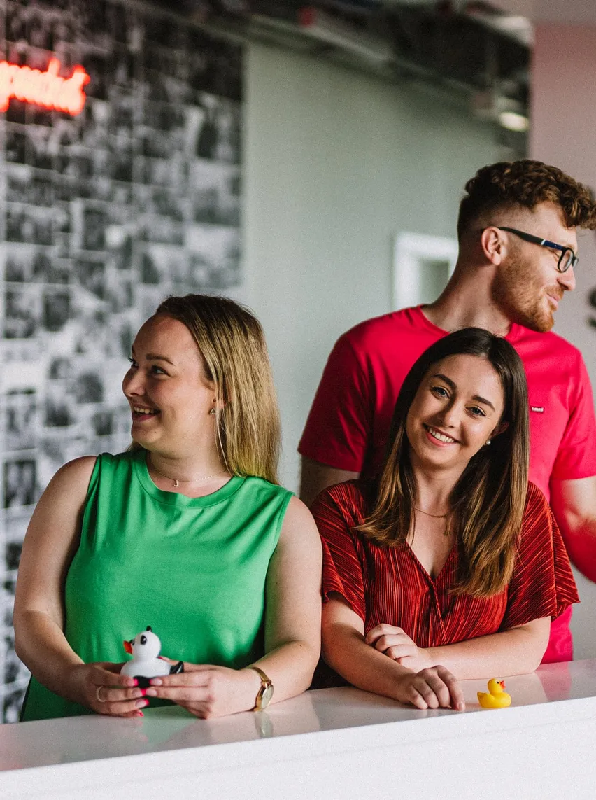 Speednet team members laughing together in the office.