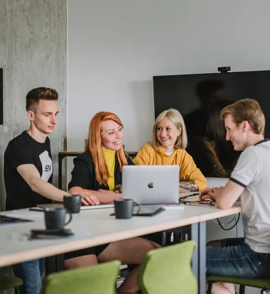 Speednet team members working together at a shared table.